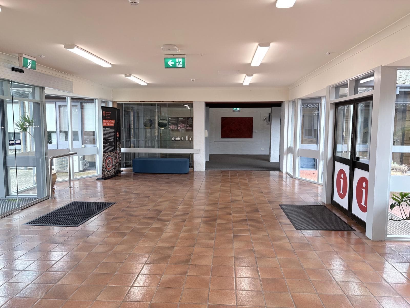 Interior foyer at Charles Sturt University Orange with freshly painted white walls and ceiling above terracotta tiled flooring