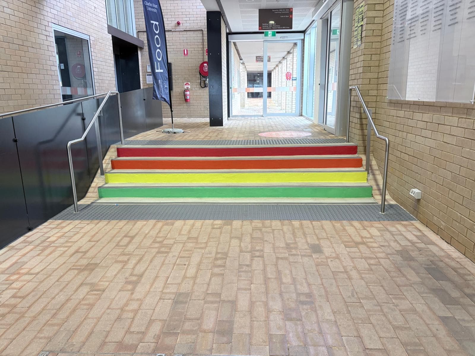 Stair nosings painted green, yellow, orange and red by Murrays Painting at the Charles Sturt University Orange campus