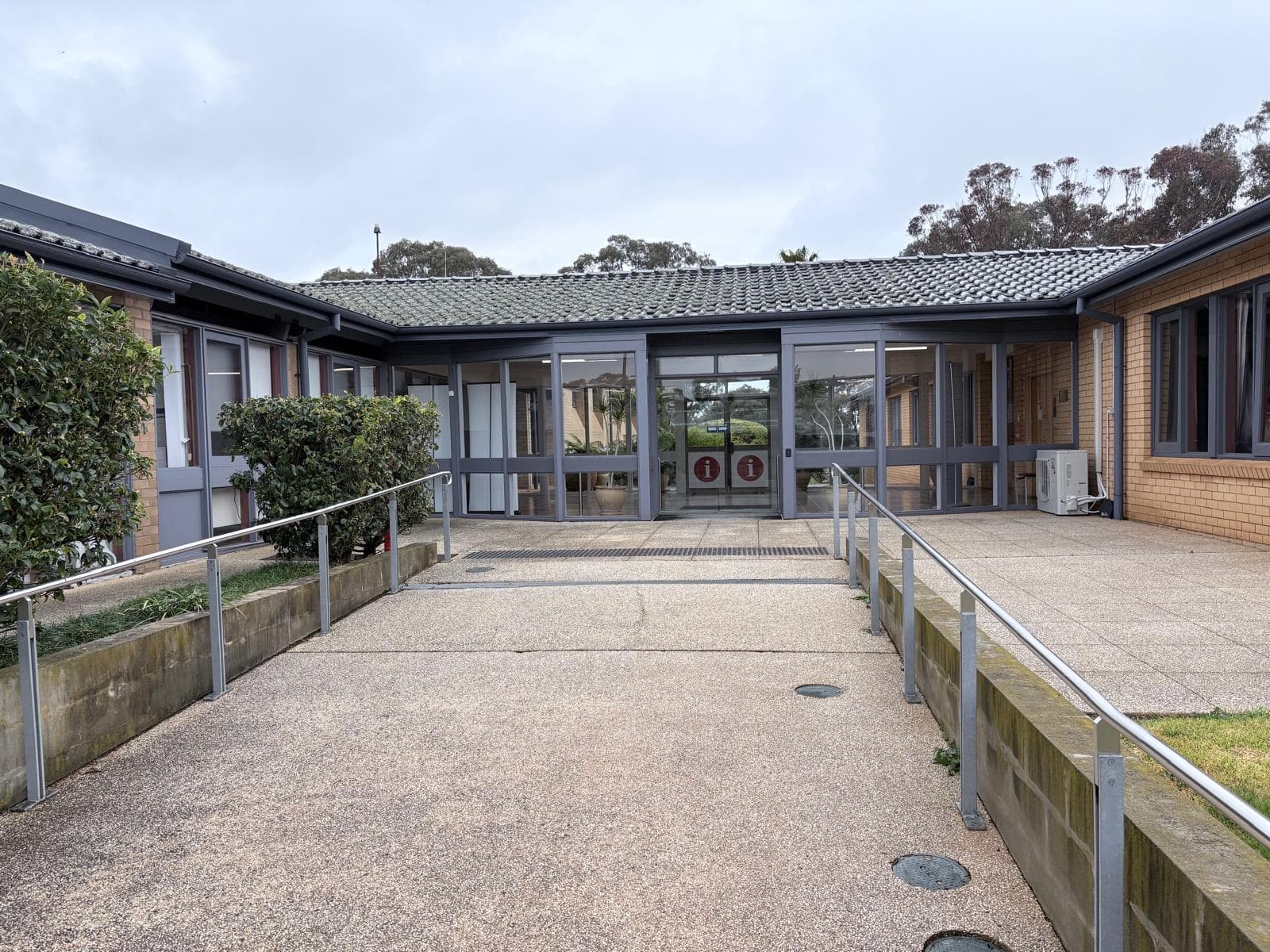 University entry courtyard with repainted charcoal window frames and fascias, Orange NSW