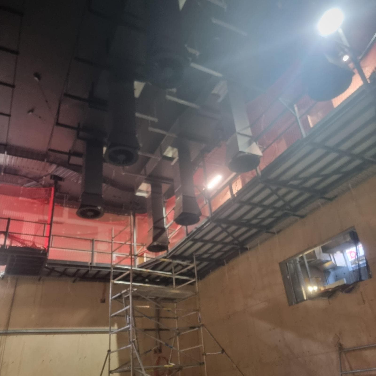 Blacked out ceiling services and structural steel above scaffold in the theatre at Orange Regional Conservatorium