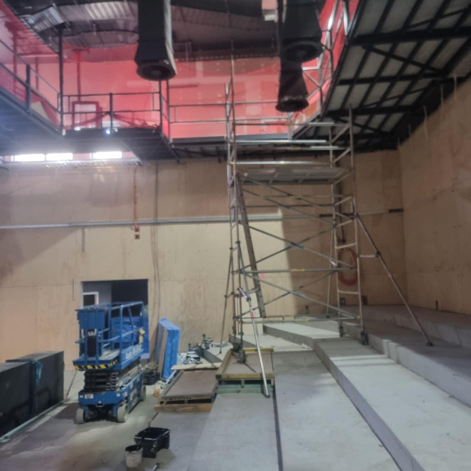 Mobile scaffold tower and scissor lift set up inside the unfinished theatre at Orange Regional Conservatorium