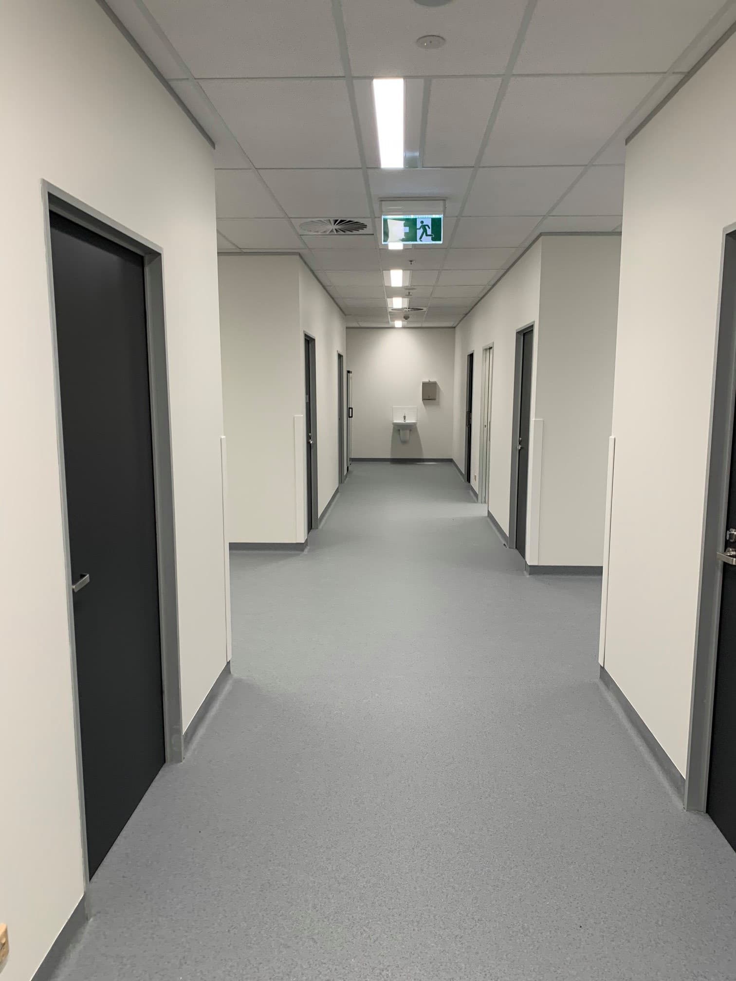 Commercial corridor with charcoal doors and white walls, Central West NSW