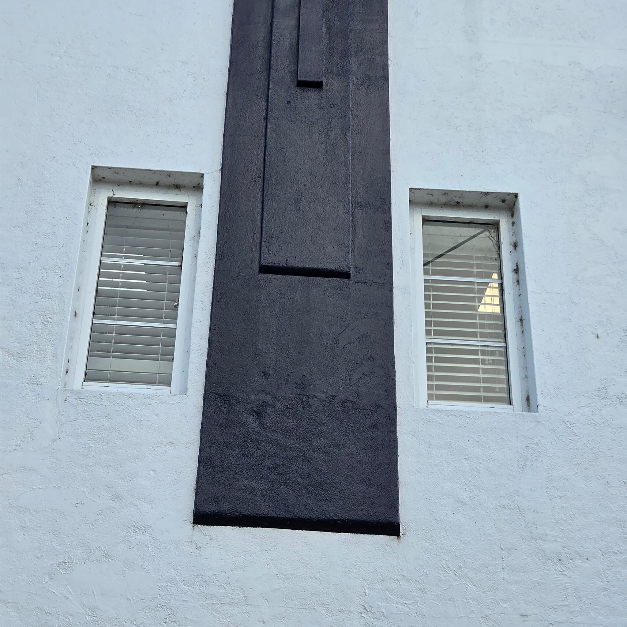 Charcoal Art Deco pilaster between two windows on a freshly painted white rendered wall, Orange NSW
