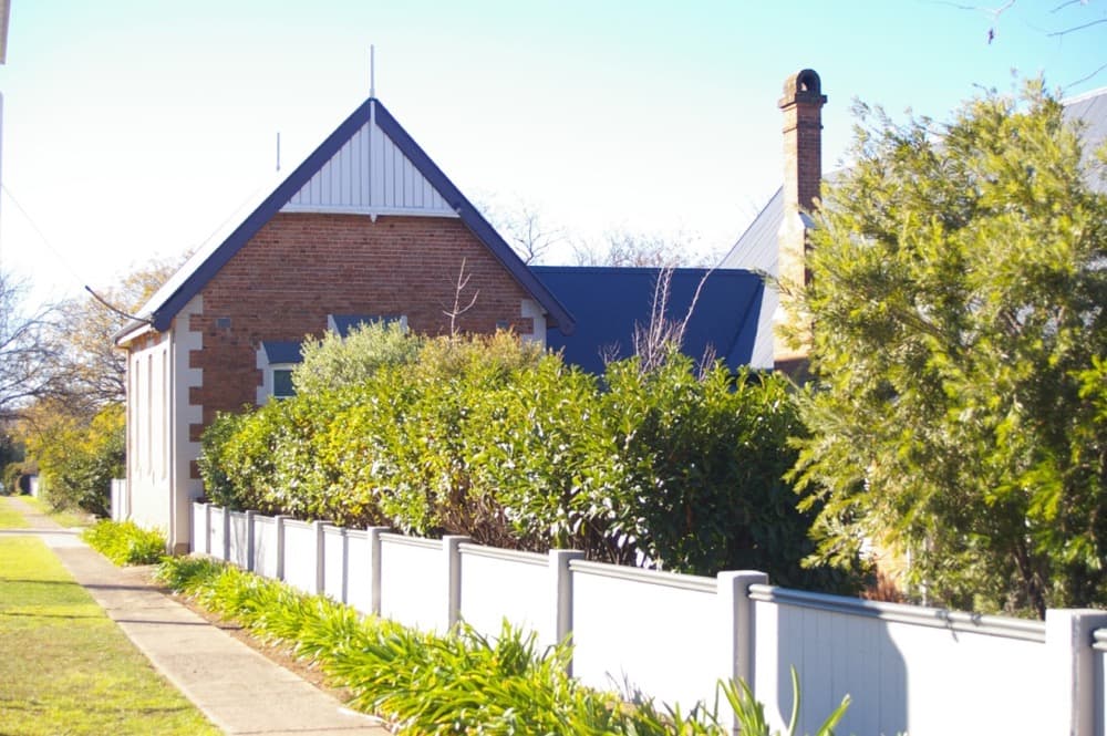 Brick house with painted fence