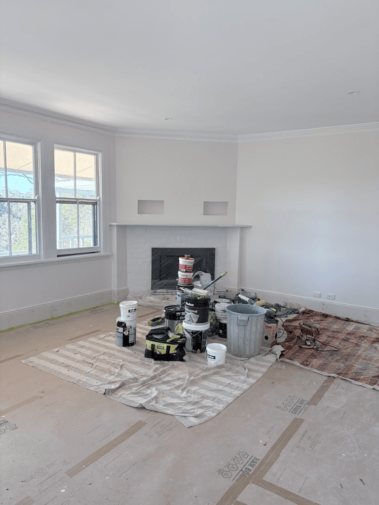 Living room with fireplace being painted