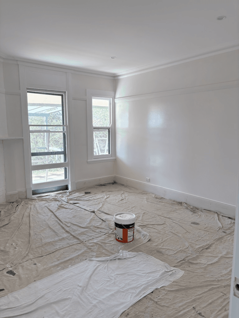 Room prepared for painting with drop sheets