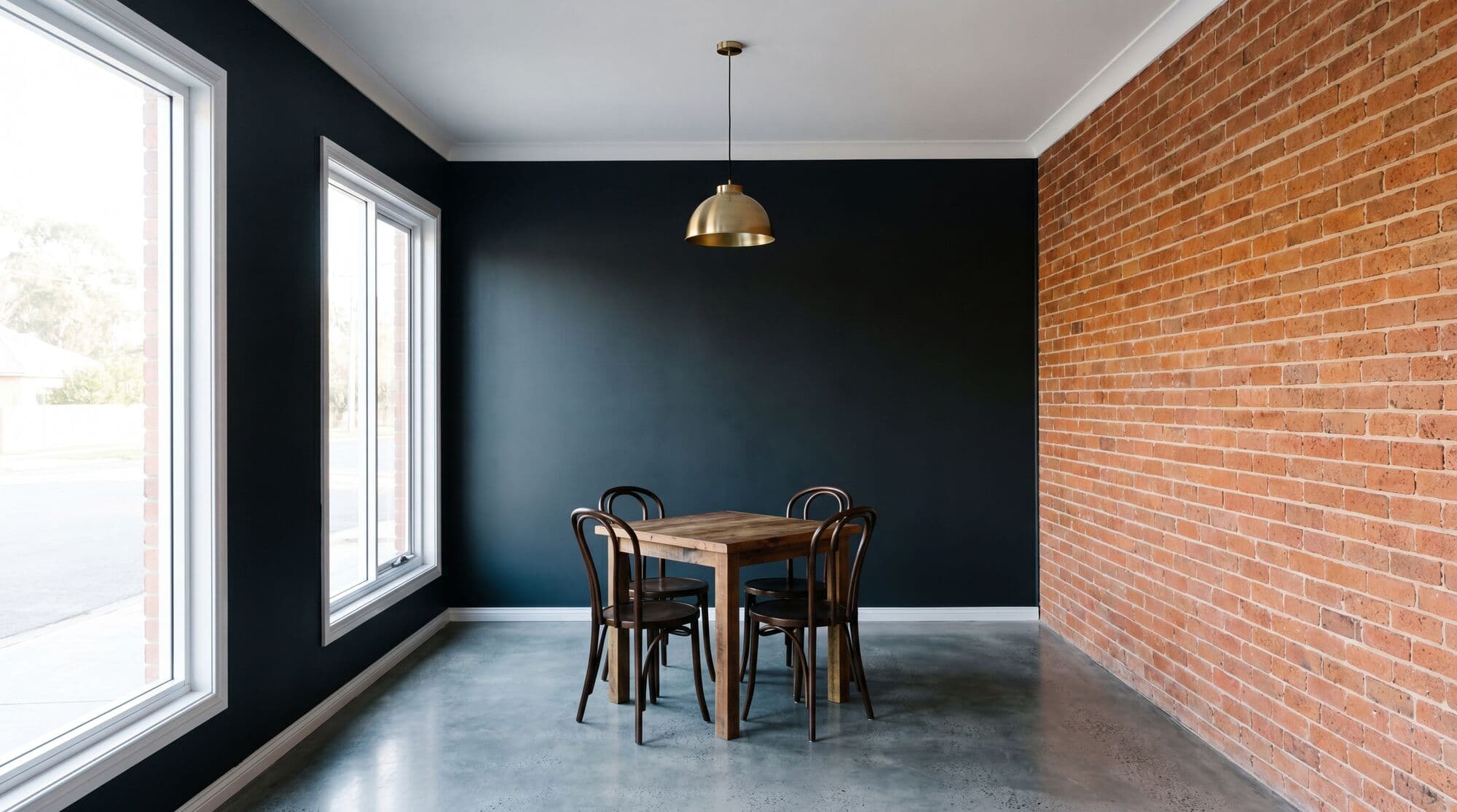 Freshly painted charcoal restaurant dining room with exposed brick, polished concrete floor, bentwood chairs